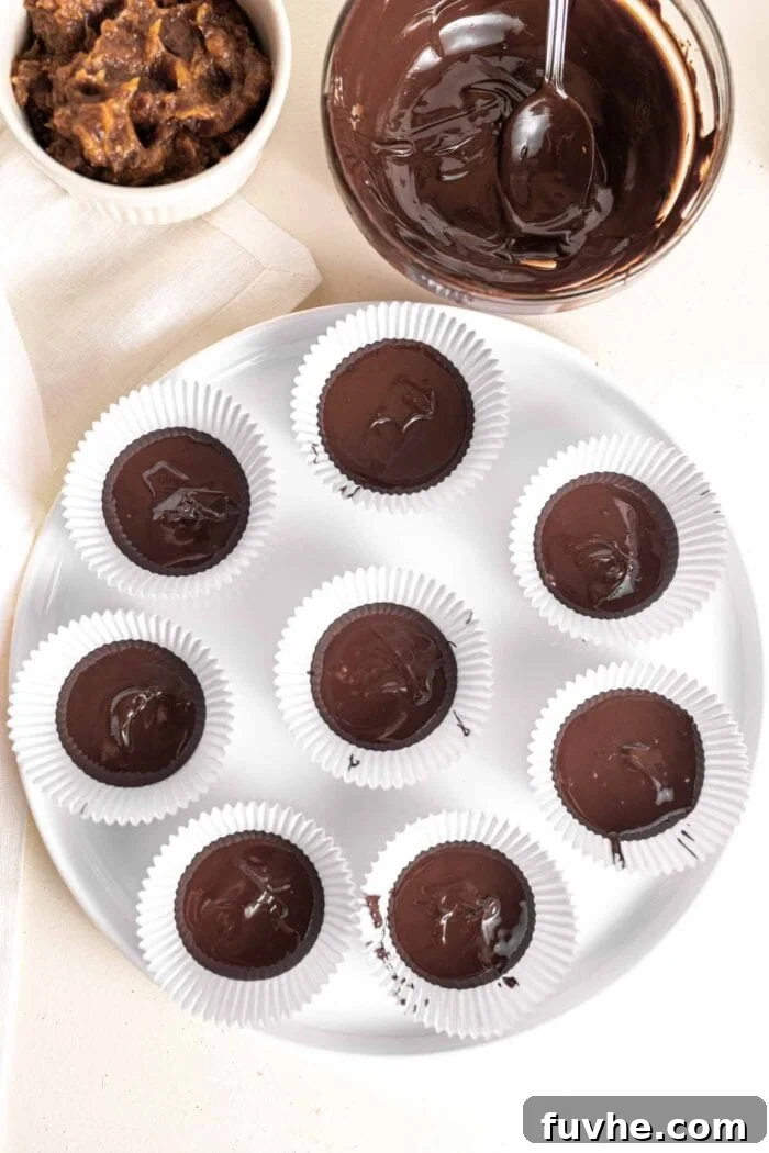 Melted chocolate bases in 12 muffin liners, chilling in the freezer.