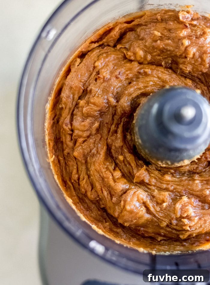 A creamy pumpkin peanut butter batter mixed up in a food processor.