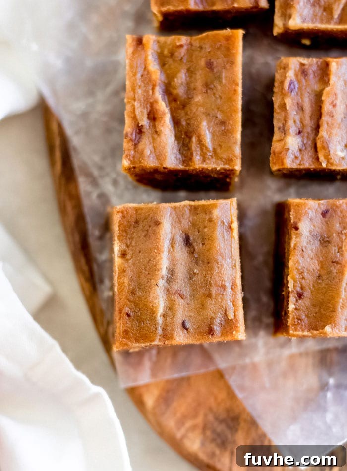 Squares of pumpkin fudge on a cutting board.