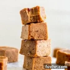 A stack of 4 pieces of pumpkin pie fudge.