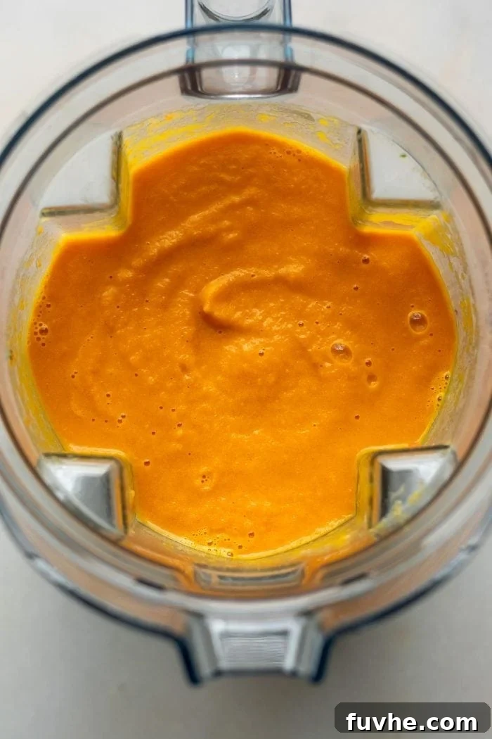 Creamy carrot soup in a blender.