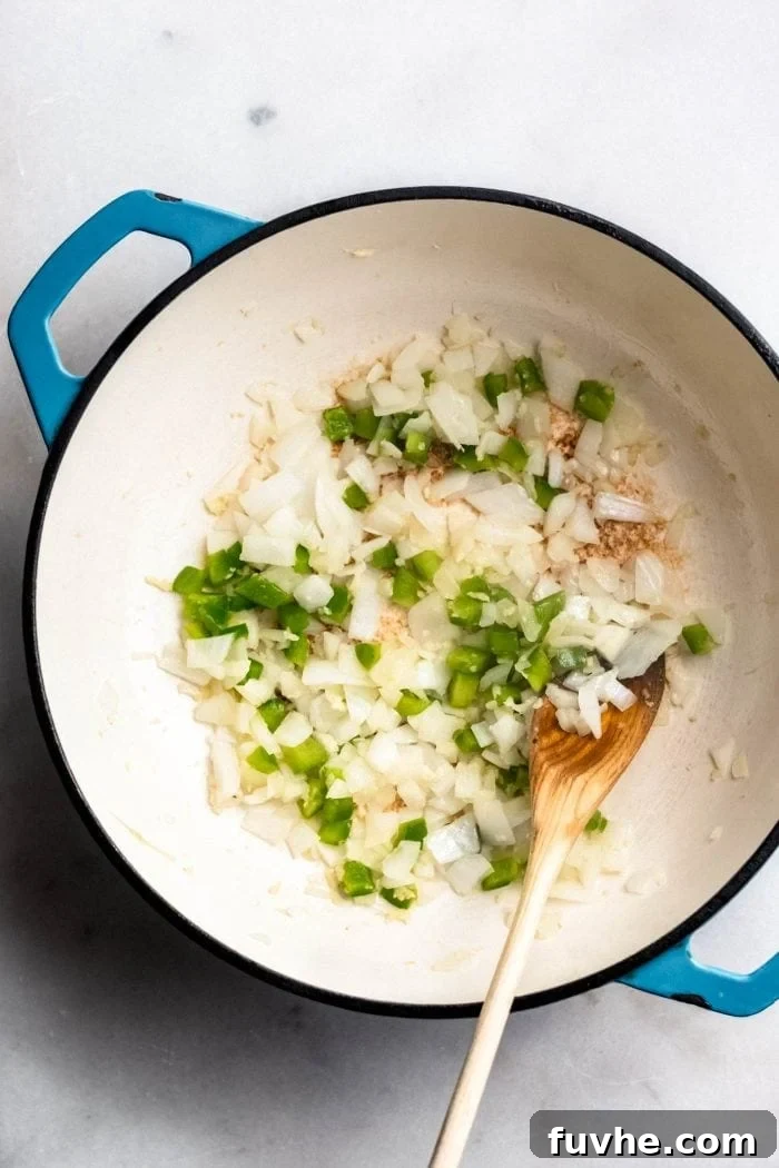 A closer view of sautéing onions, garlic, and jalapeno in a soup pot, their fragrances beginning to meld beautifully.