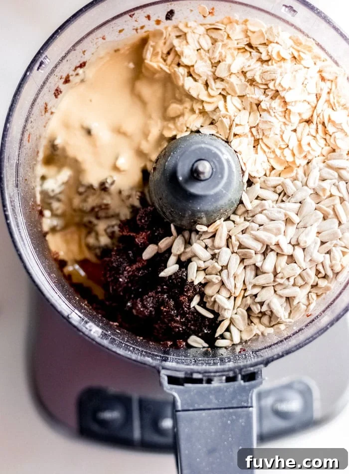 Deliciously Simple No Bake Granola Bars 3 Oats, raisins and tahini in a food processor container.