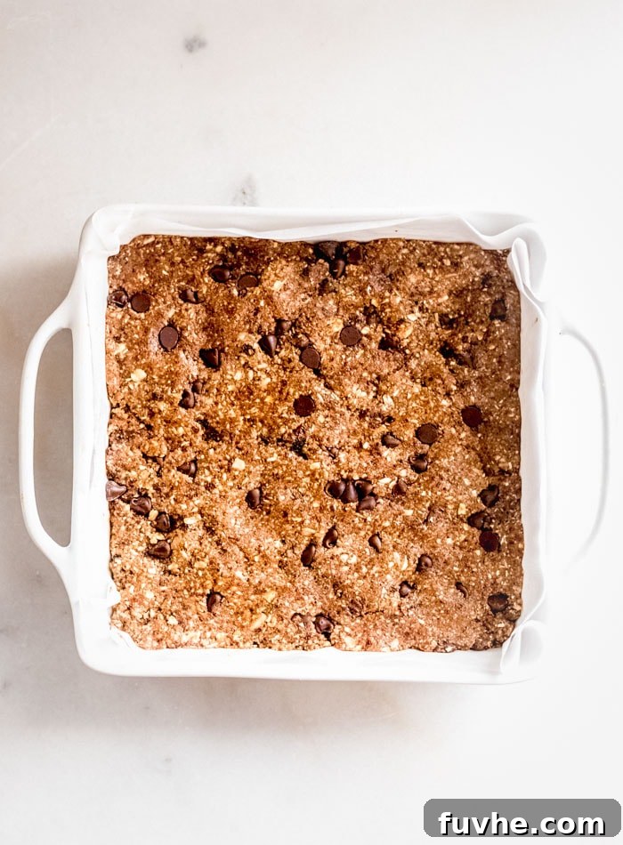 Deliciously Simple No Bake Granola Bars 6 A baking dish of chocolate chip granola bars.