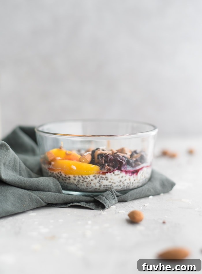 A beautiful Coconut Chia Pudding Breakfast Bowl, topped with fresh berries, sliced almonds, and a drizzle of almond butter.