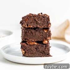 Plant-Powered Protein Brownies 9 Stack of 3 chocolate brownies on a small white plate, ready to be enjoyed.