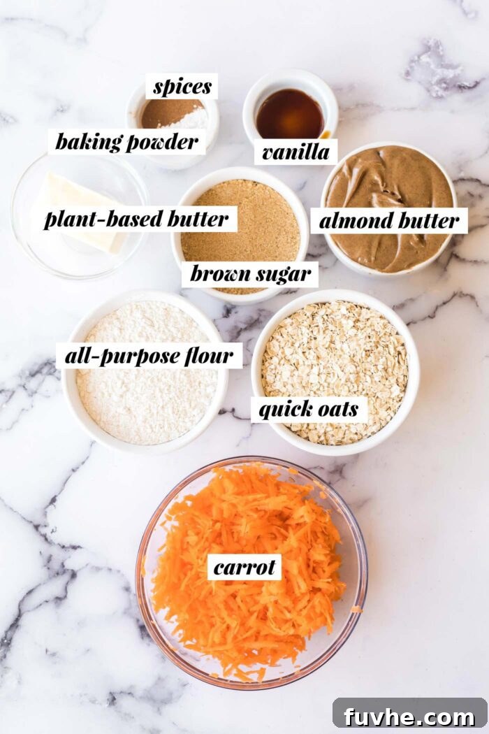 Carrot Cake Oatmeal Cookies 3 A flat lay photograph of all the wholesome ingredients laid out for making vegan carrot cake cookies: oats, brown sugar, almond butter, all-purpose flour, spices, and fresh carrots.