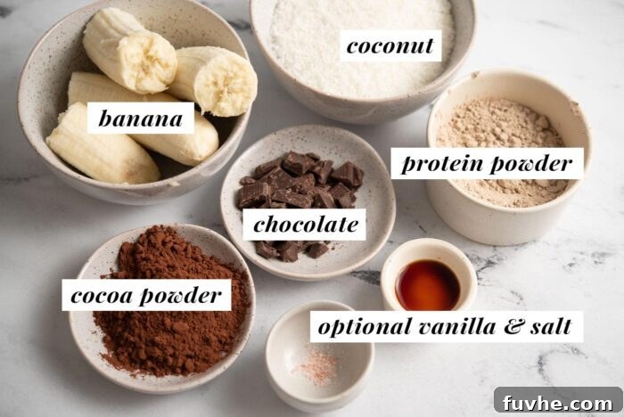 A visual display of the five core ingredients required for making healthy vegan coconut protein brownies, including ripe bananas, shredded coconut, protein powder, cocoa, and chocolate chips.