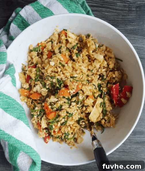 Mastering Macros: 23 Vegan Meals and Snacks 5 Low-fat peanut cauliflower rice bowl with veggies and sriracha, a quick and macro-friendly vegan meal.