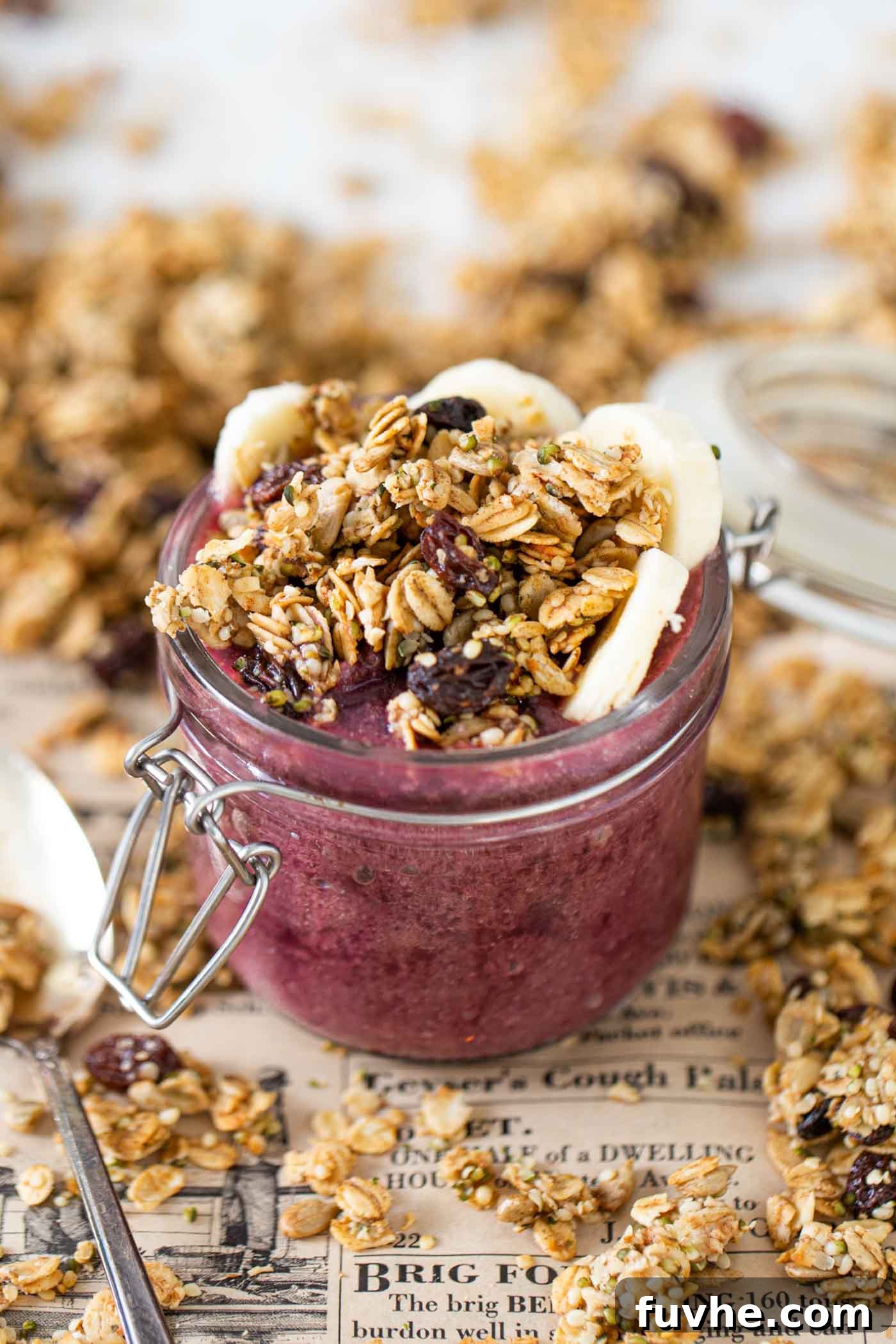 Guilt-Free Granola Crunch 2 A vibrant berry smoothie topped with golden, crunchy granola, served attractively in a clear glass jar.