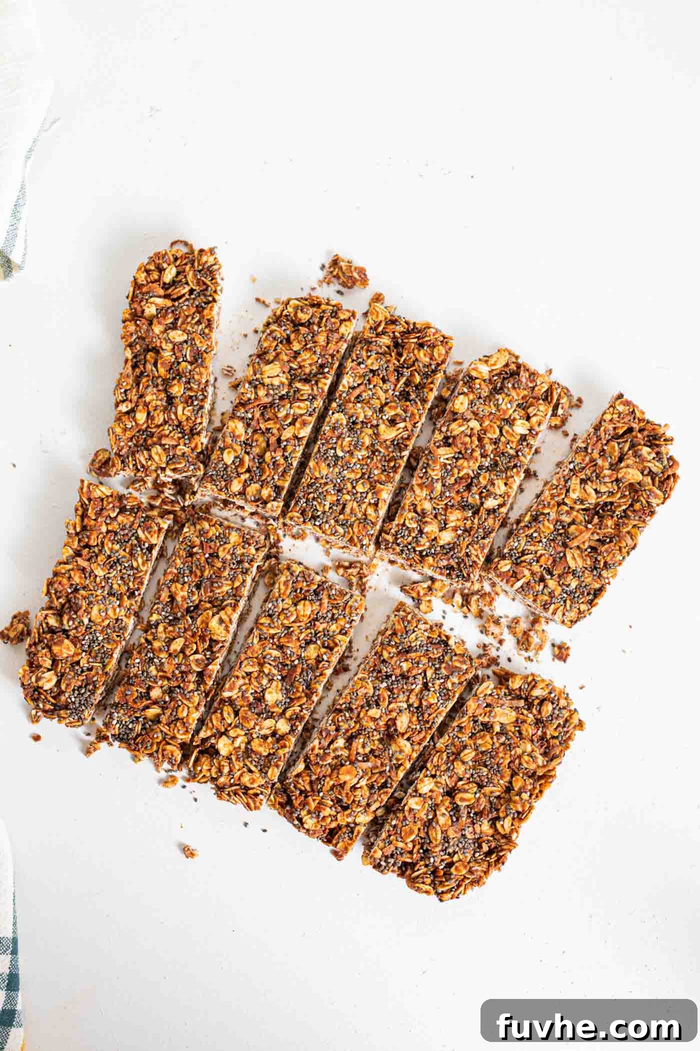 Eight perfectly sliced no-bake chocolate oat bars, adorned with tiny chia seeds, ready for a healthy indulgence.