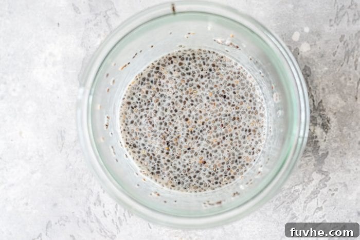 Thick, creamy vanilla chia seed pudding in a glass jar, ready for toppings.