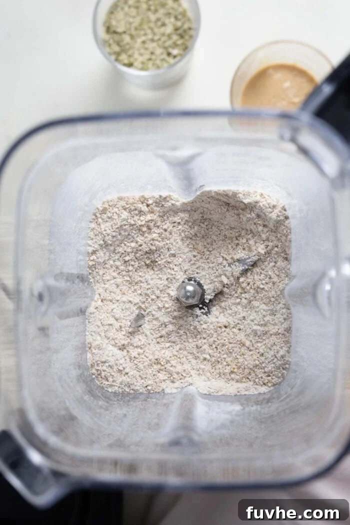 Coarsely blended oats in a food processor, ready for the next ingredients.