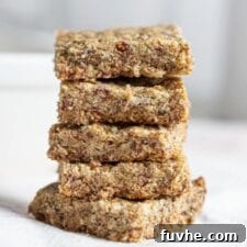 Stack of baked tahini bars on a mobile surface.