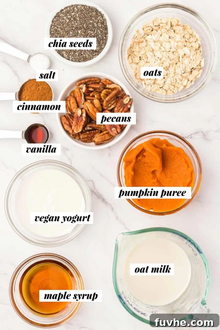Spiced Pumpkin Overnight Oats 3 All the ingredients needed for making a pumpkin pie overnight oatmeal recipe, laid out on a white surface.