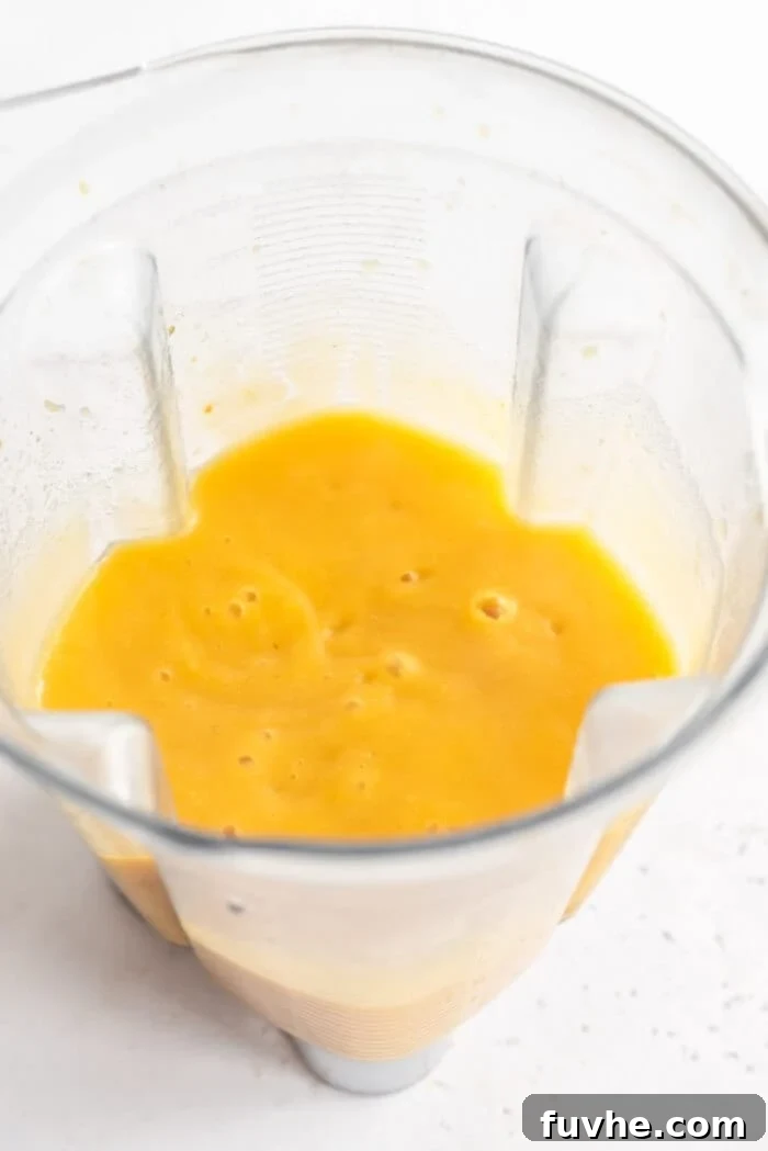 Velvety Cauliflower Potato Comfort 7 A smooth, creamy portion of cauliflower potato soup being blended to perfection in a Vitamix blender, ready to be rejoined with the chunky base.