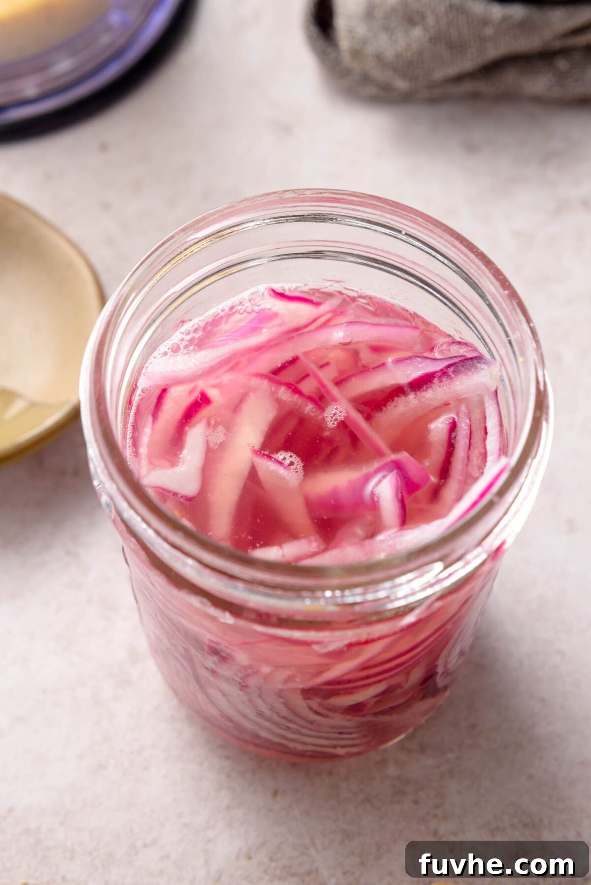 Golden Roasted Vegetable Caesar 6 Glass jar filled with quick-pickled red onions in pink brine, ready to be added to the salad.