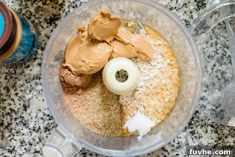 Almond butter, oats, cacao powder, flax seed, honey, coconut oil and vanilla in a food processor. 