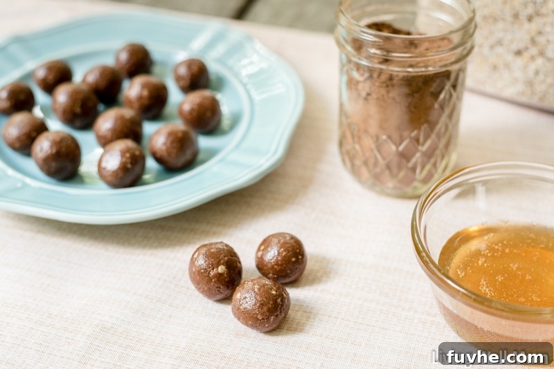 no bake protein balls on a blue plate, and a few on a placemat