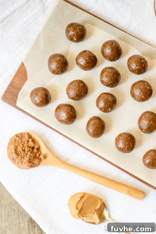 chocolate protein balls on a lined cutting board