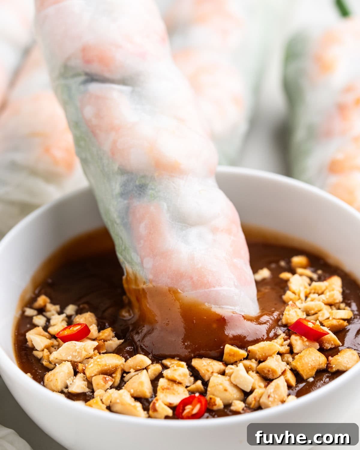 Vietnamese Fresh Spring Rolls (Gỏi Cuốn) — Authentic Recipe 17 dipping spring roll into peanut sauce.