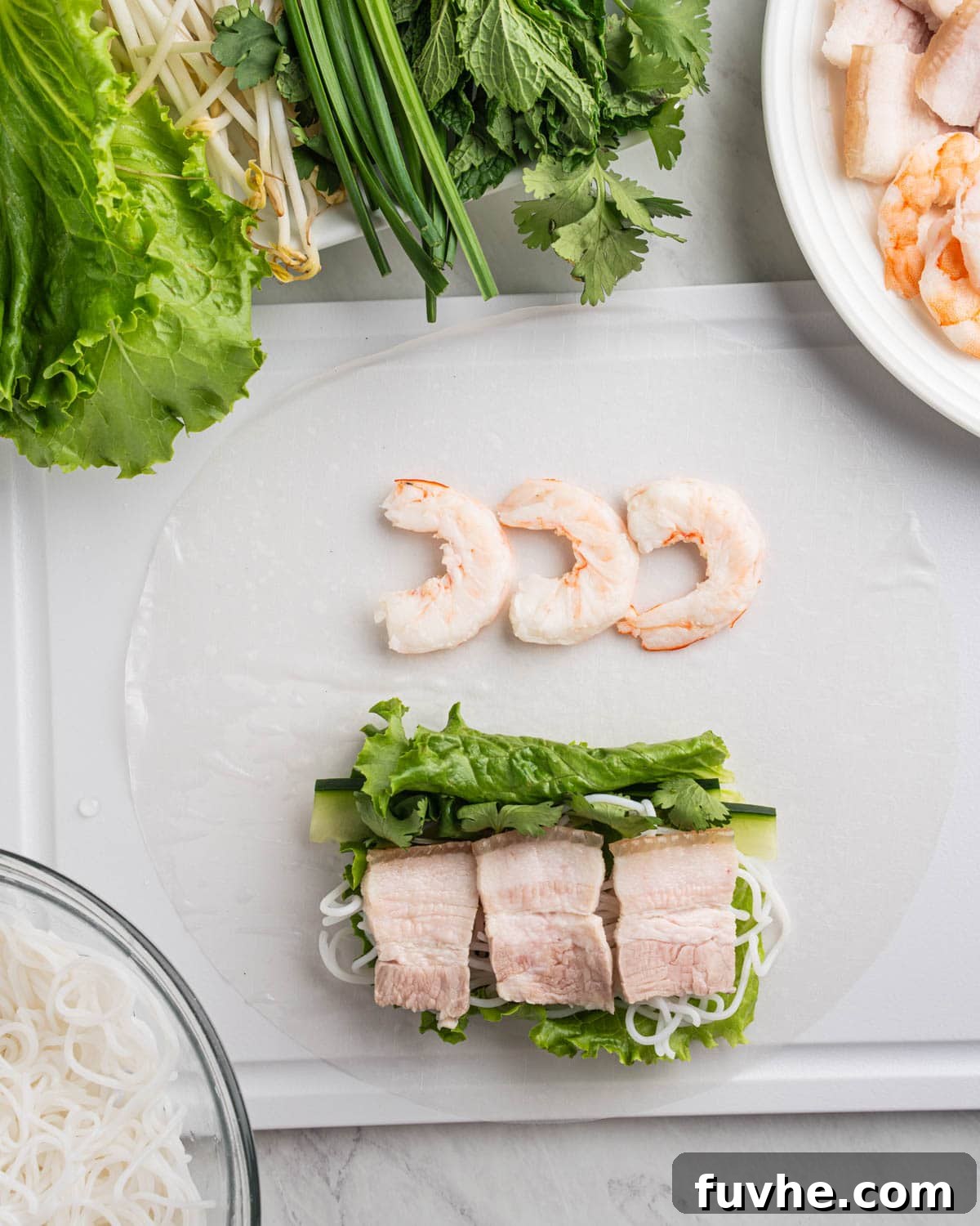 Vietnamese Fresh Spring Rolls (Gỏi Cuốn) — Authentic Recipe 10 pork belly and shrimp on rice paper along with other ingredients for spring rolls.